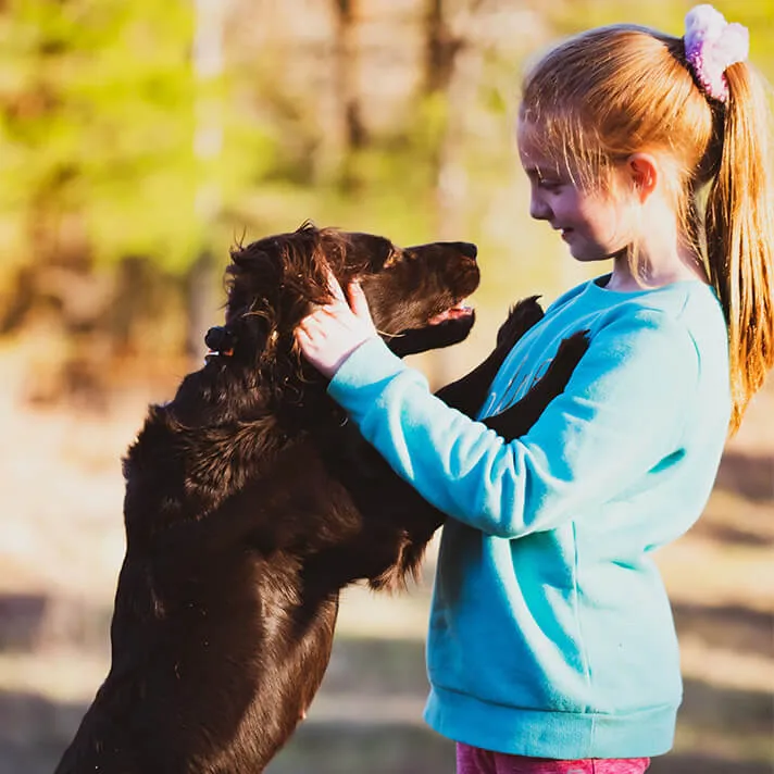 Girl Holding Dog